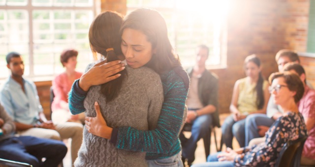 Photo of women hugging at group therapy