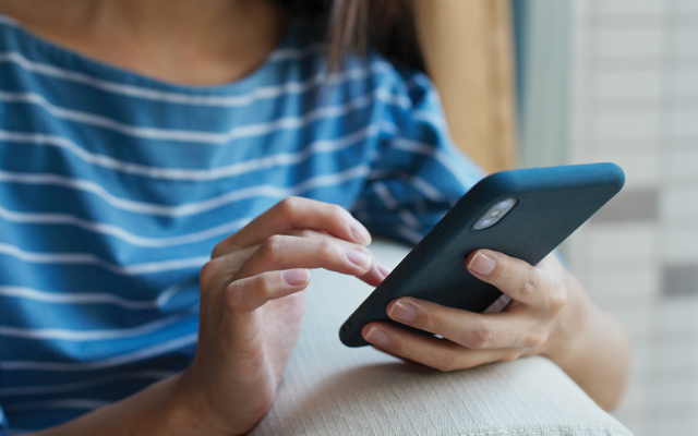 Photo of woman holding a phone