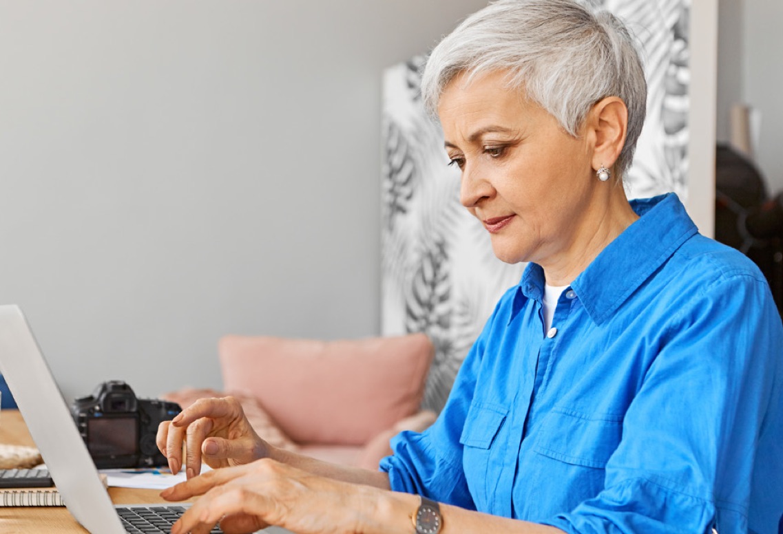 Senior woman looking at laptop