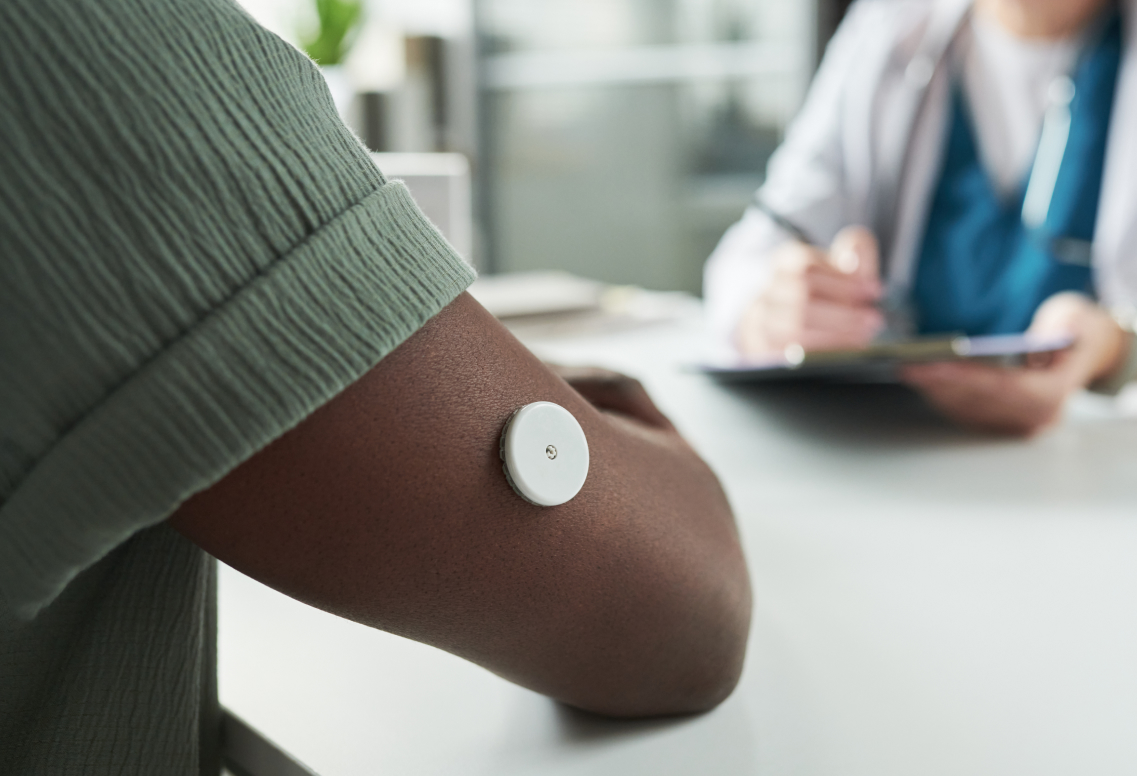 Photo of man wearing glucose monitor