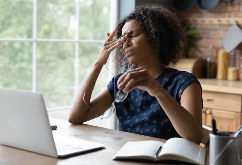 Employee at desk feeling stressed out