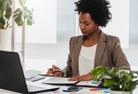 woman reviewing files at desk