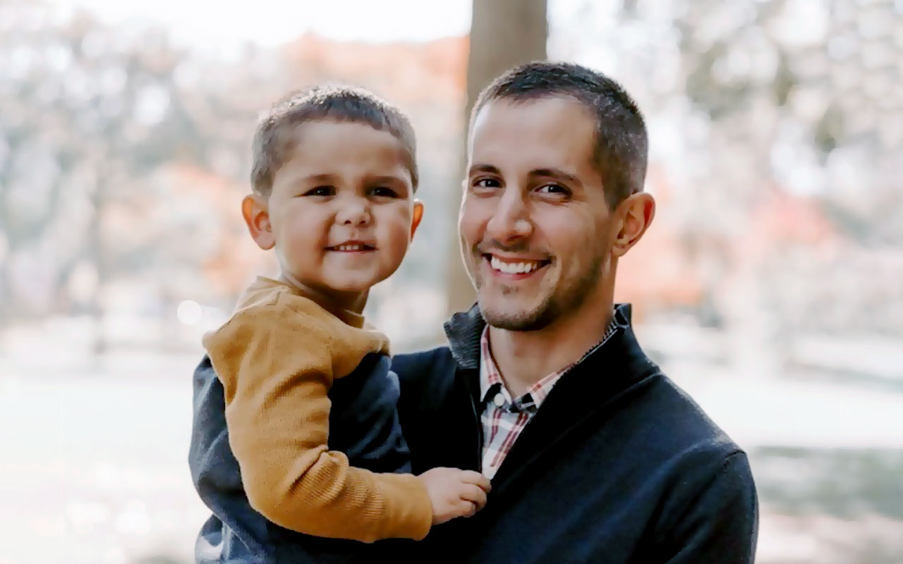 Photo of a man holding his toddler son