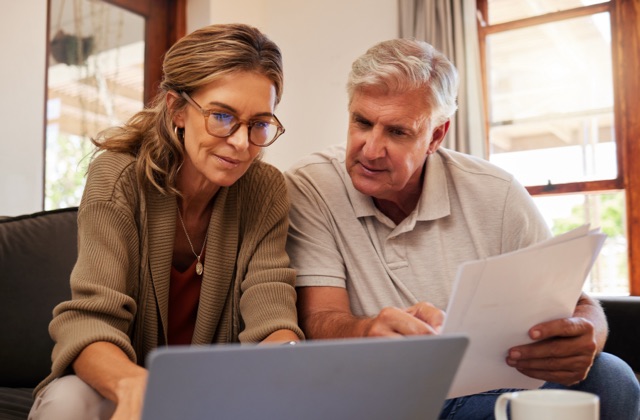 Photo of older couple looking at laptop