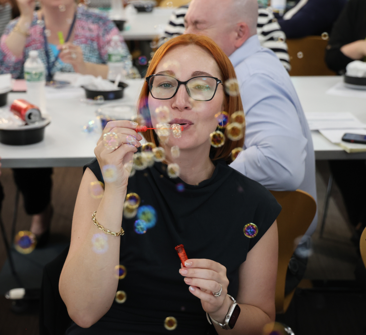 Photo BCBSRI associate blowing bubbles at the 2025 Belonging Week