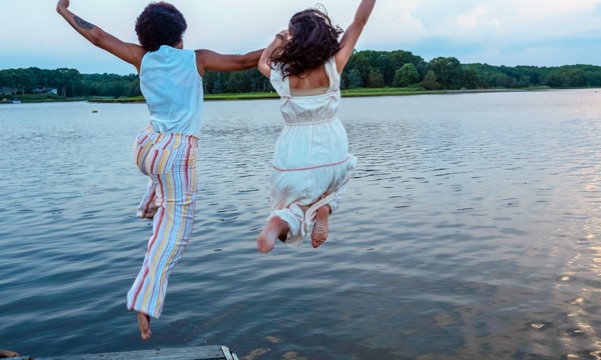 Girls jumping into water