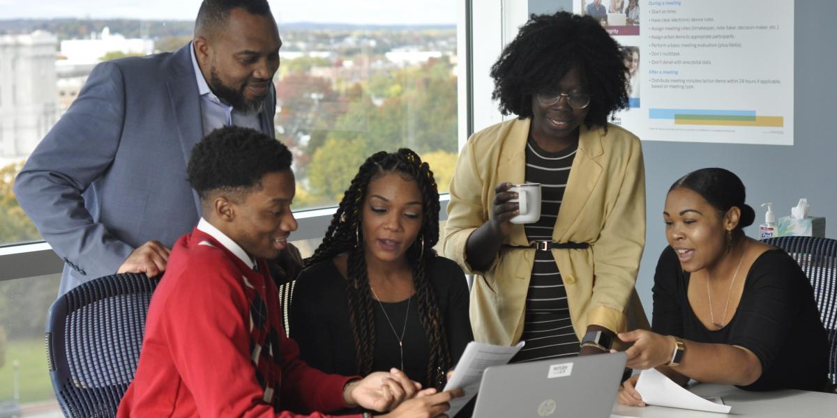 group of colleagues around a computer