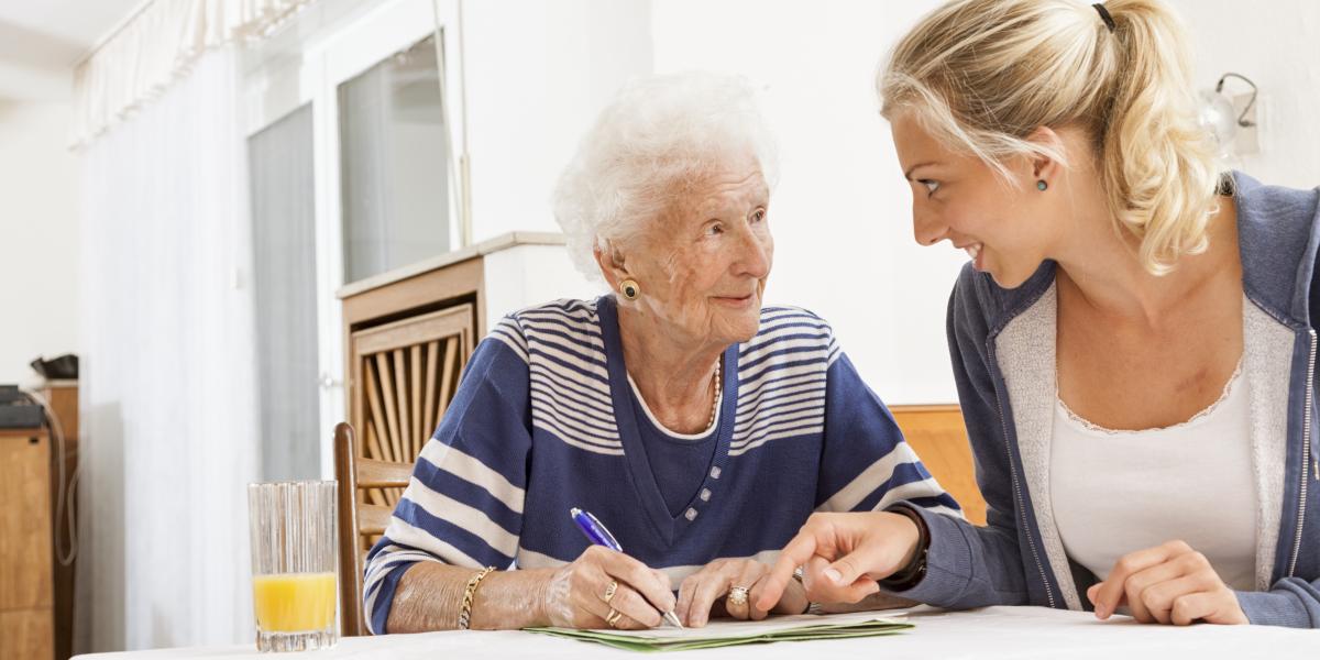 elderly woman at table with young woman