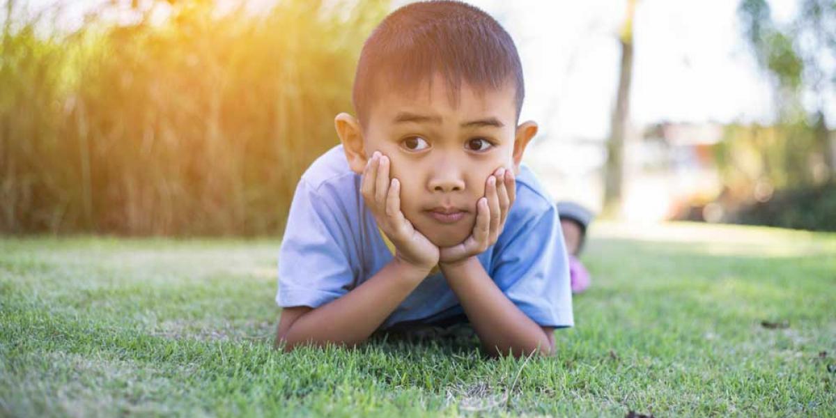 boy laying on grass