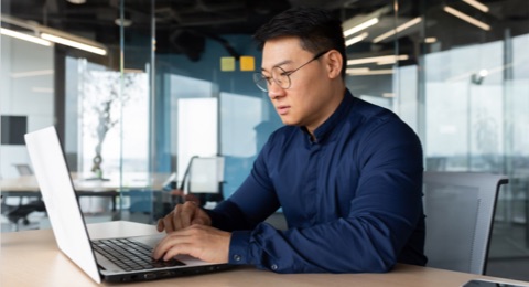 Photo of man working on laptop