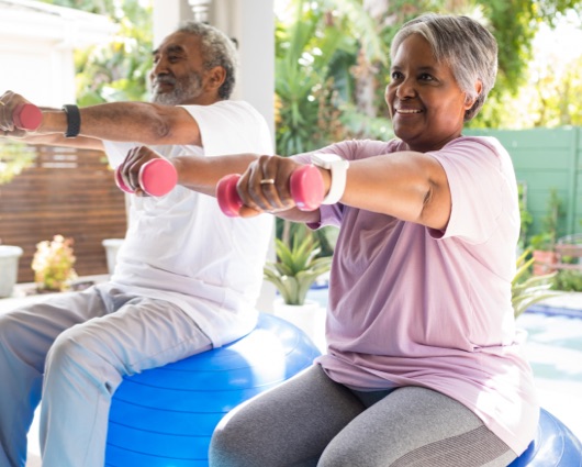 Senior couple exercising at home