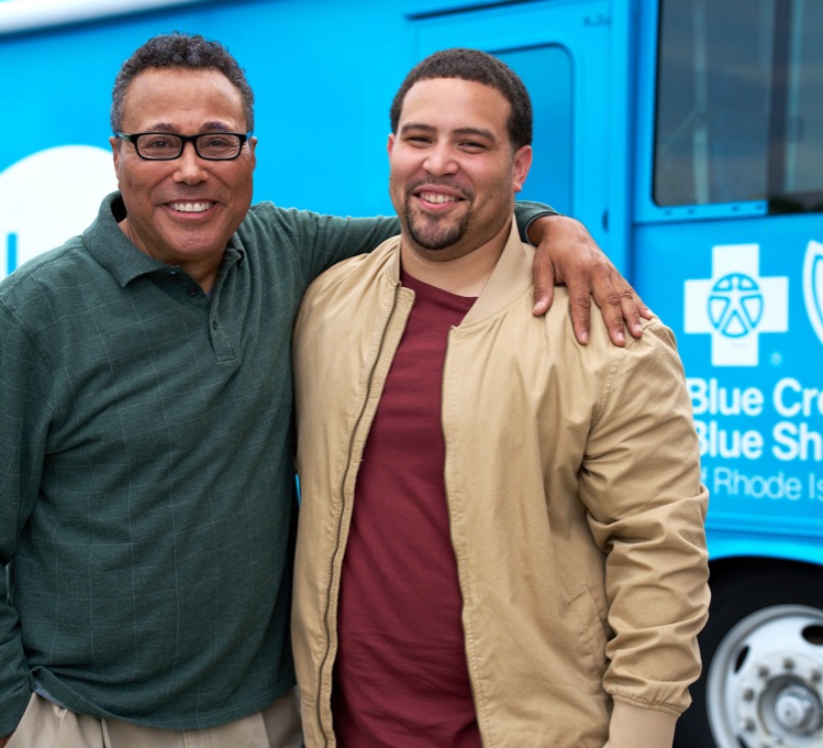 Senior father with his son visiting Your Blue Bus