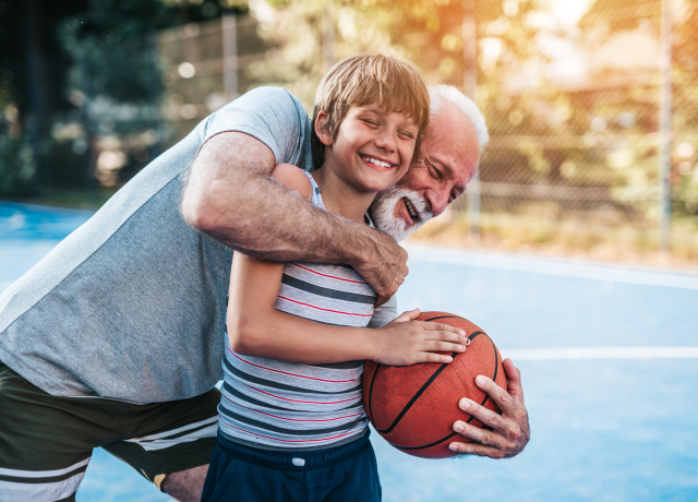 Grandfather playing basketball with his grandson