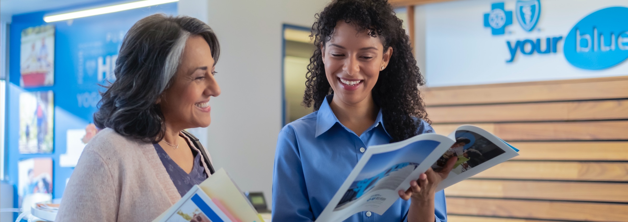 BCBSRI associate talking to woman at Your Blue Store